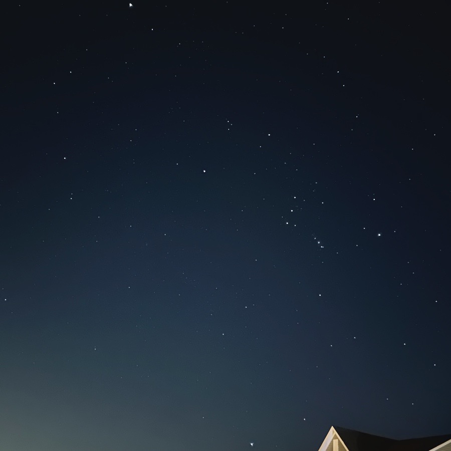 Orion and surrounding stars above New Jersey rooftops