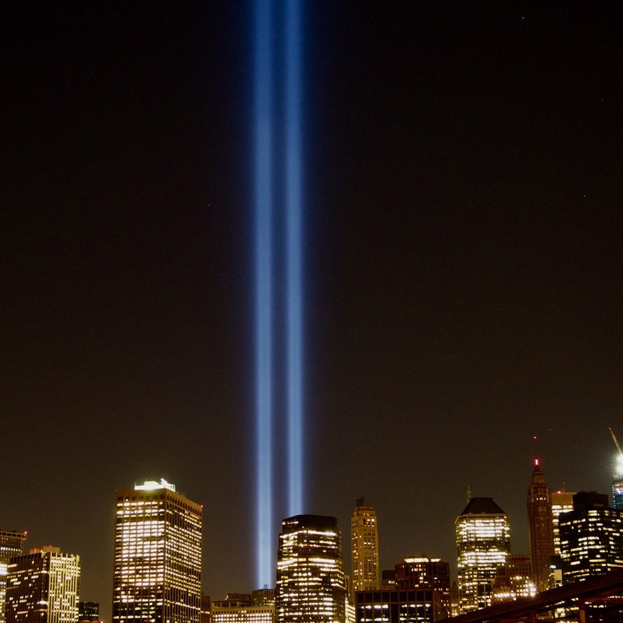 The Tribute in Light rising above New York City beneath a mostly starless night sky